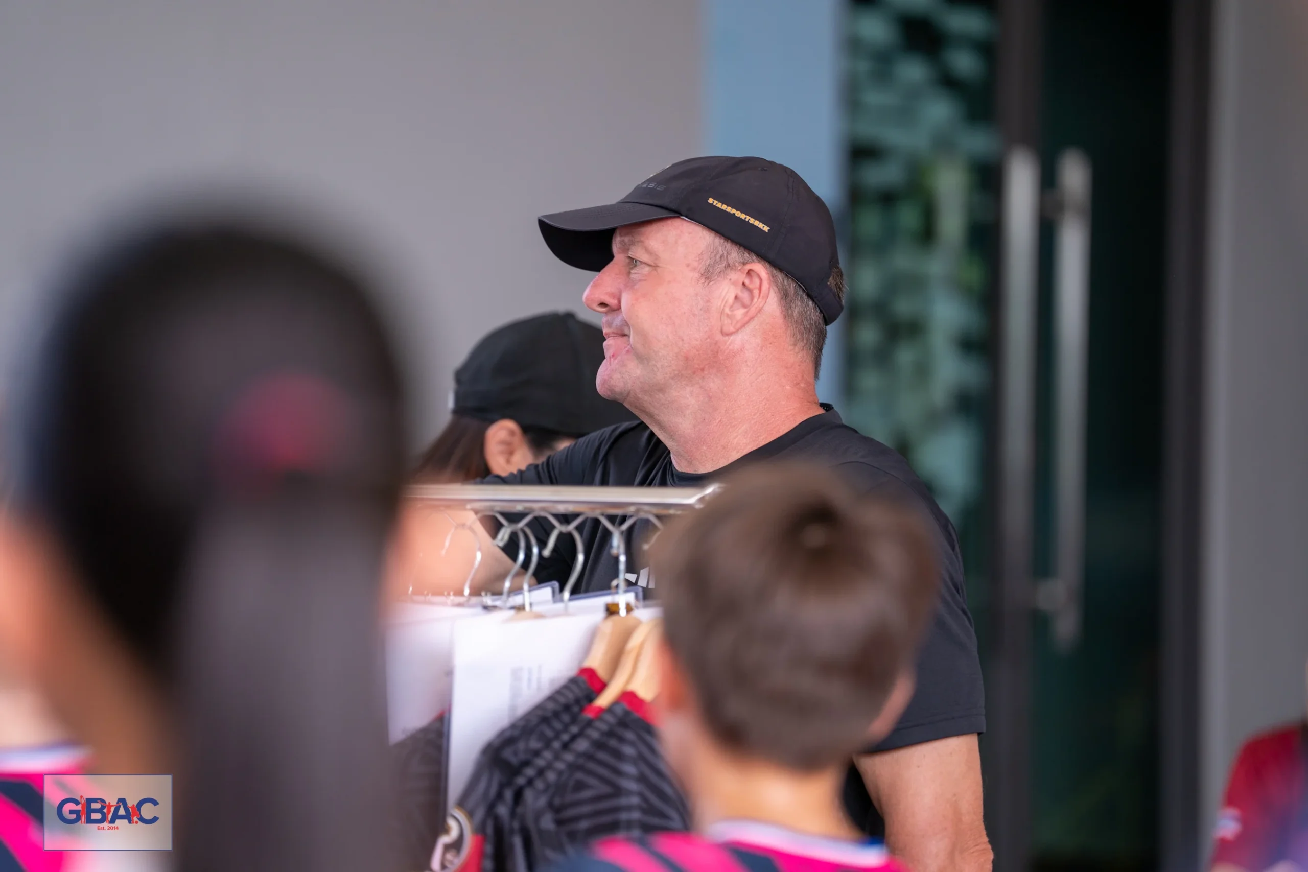 Ivan with students at the merchandise booth