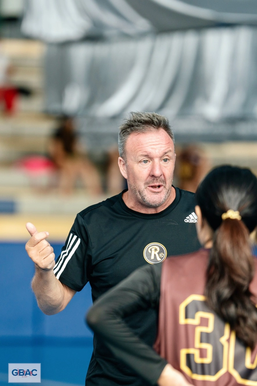 Ivan Rock providing guidance to a female basketball player at GBAC All-Stars
