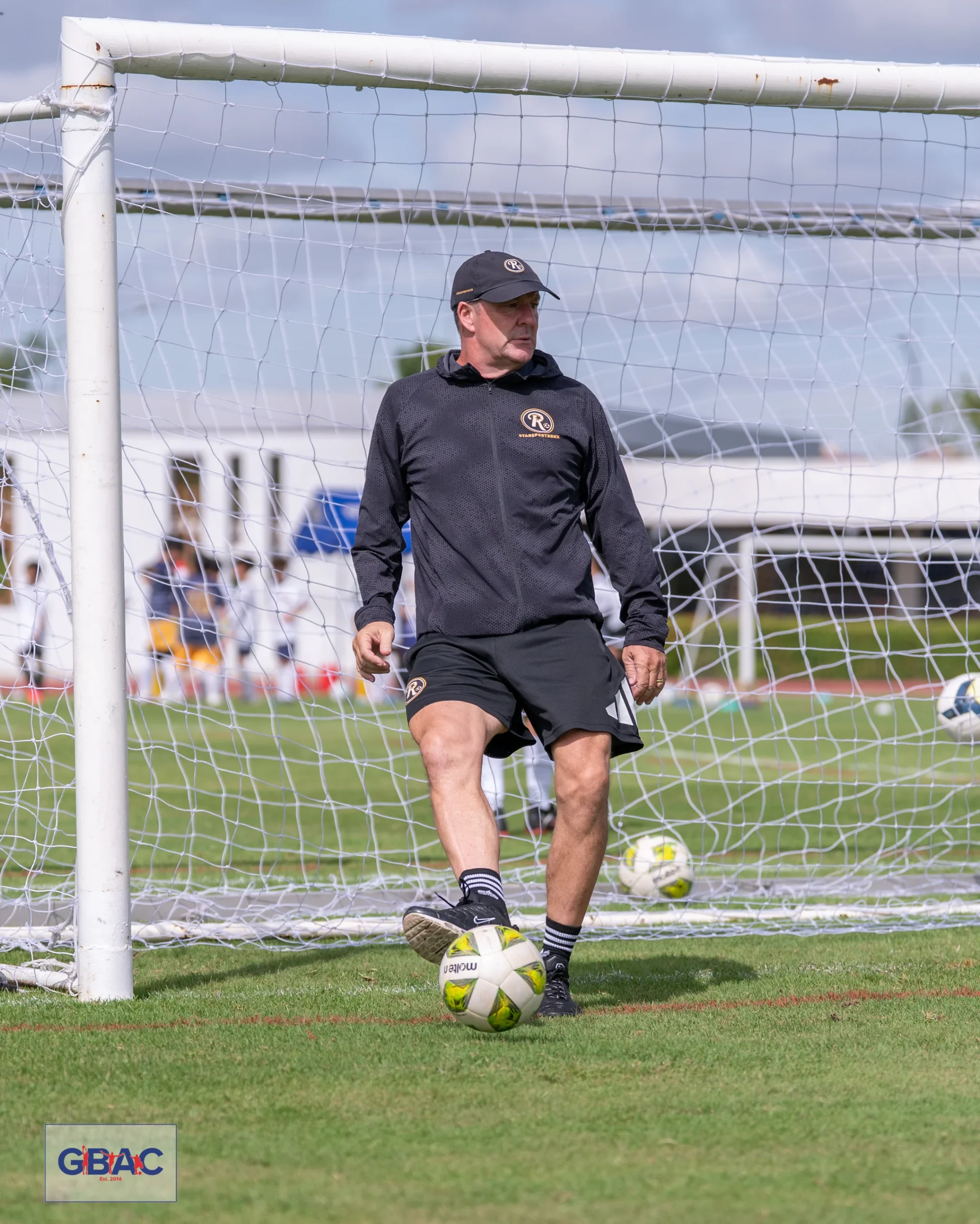 Coach Ivan prepares a football training session during a GBAC youth event